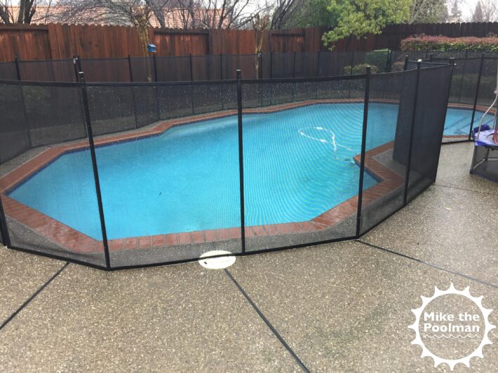 Pool mesh safety fence over skimmer lid